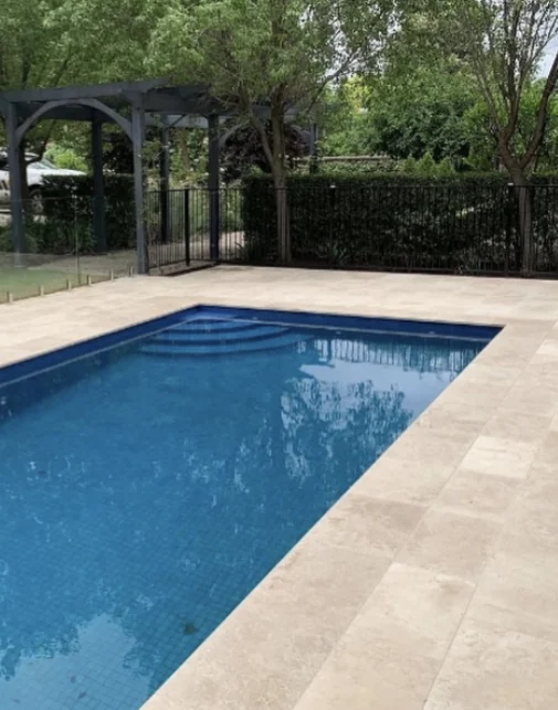 Backyard with pool and pale paving, shown in Valley’s supplied before and after post